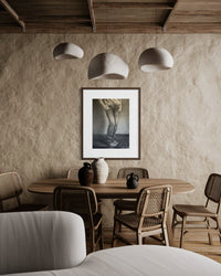 She Stands fine art print in a wood frame with white mat in a rustic dining room — mat and frame not included